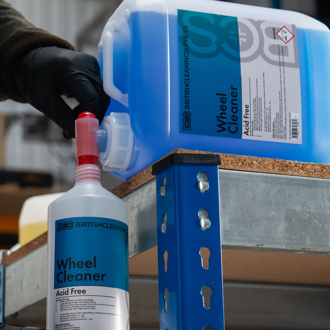 BCS Wheel Cleaner container decanting into bottle on a metal shelf.
