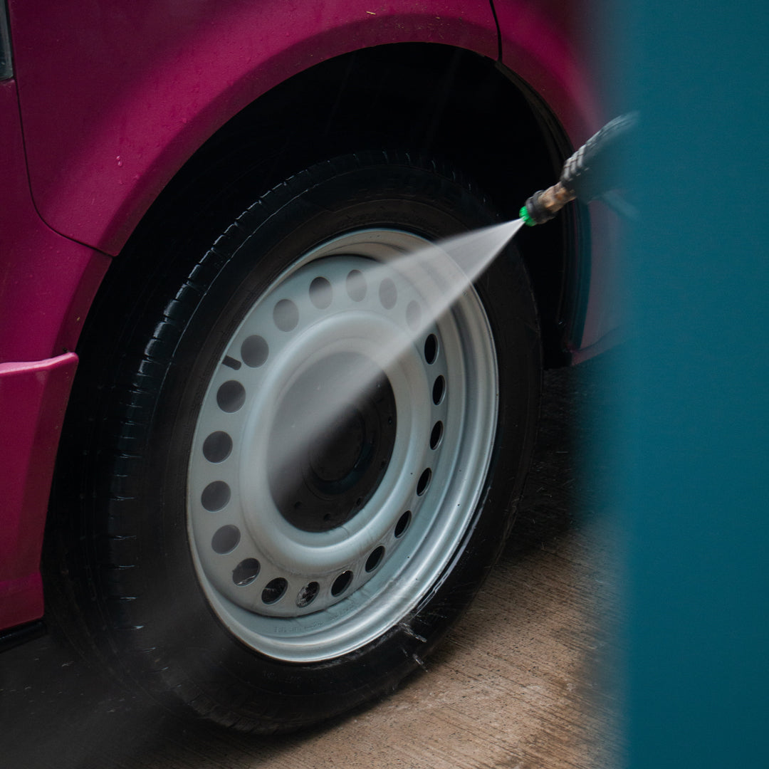 Wheel being rinsed after being cleaned with acidic wheel cleaner