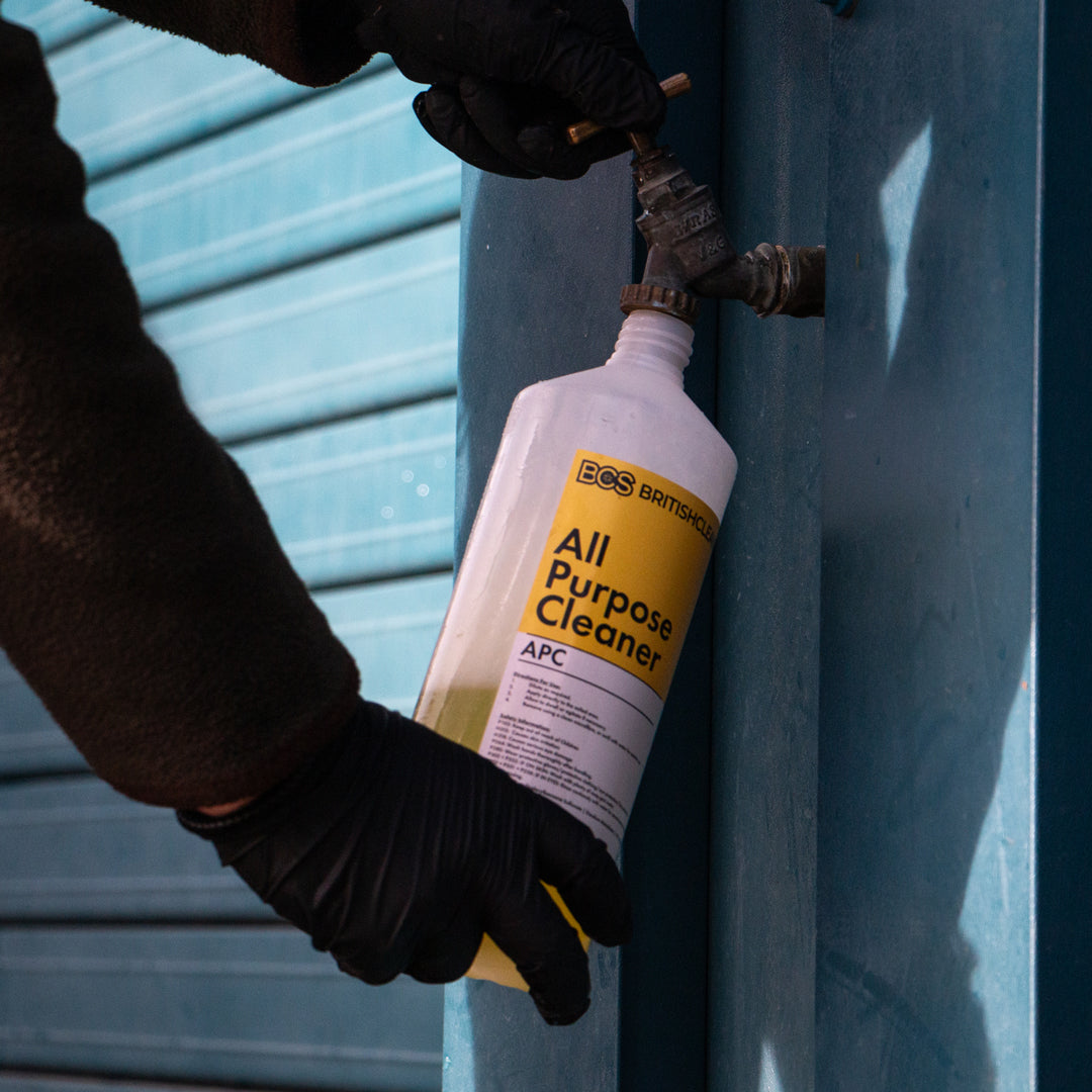 Bottle of BCS All Purpose Cleaner being diluted with water.