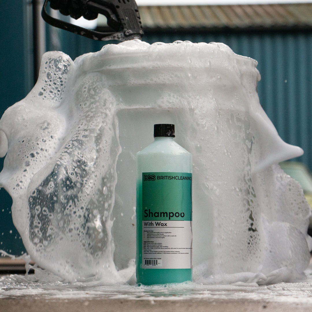 Bottle of BCS Shampoo with wax with the foam it produces coming from the bucket