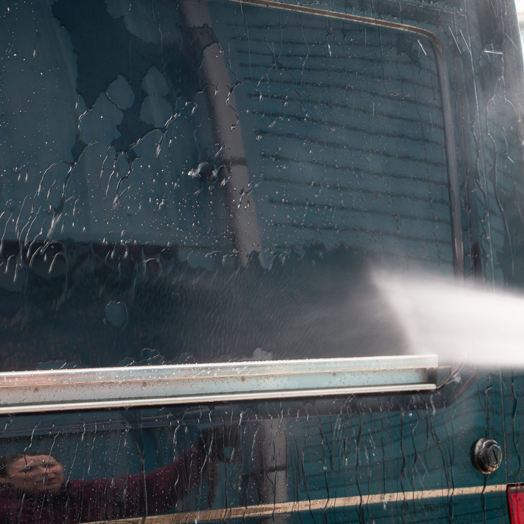 Water being sprayed on van to rinse away BCS Super Rinse
