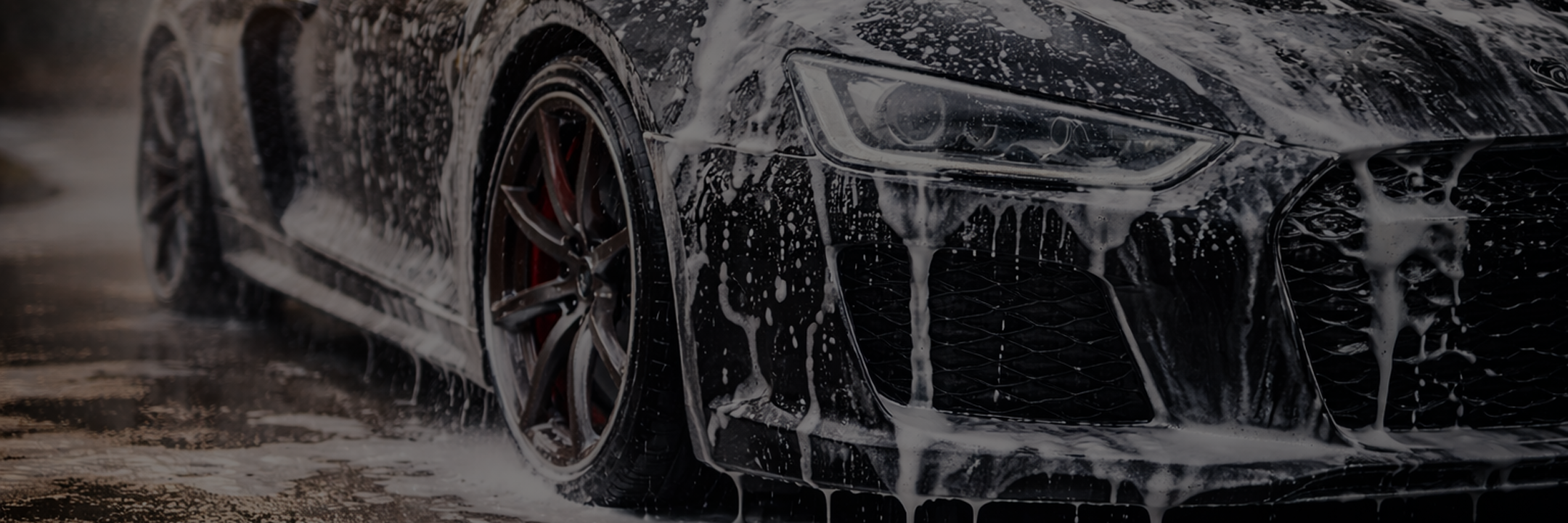 Soap running down black sports car