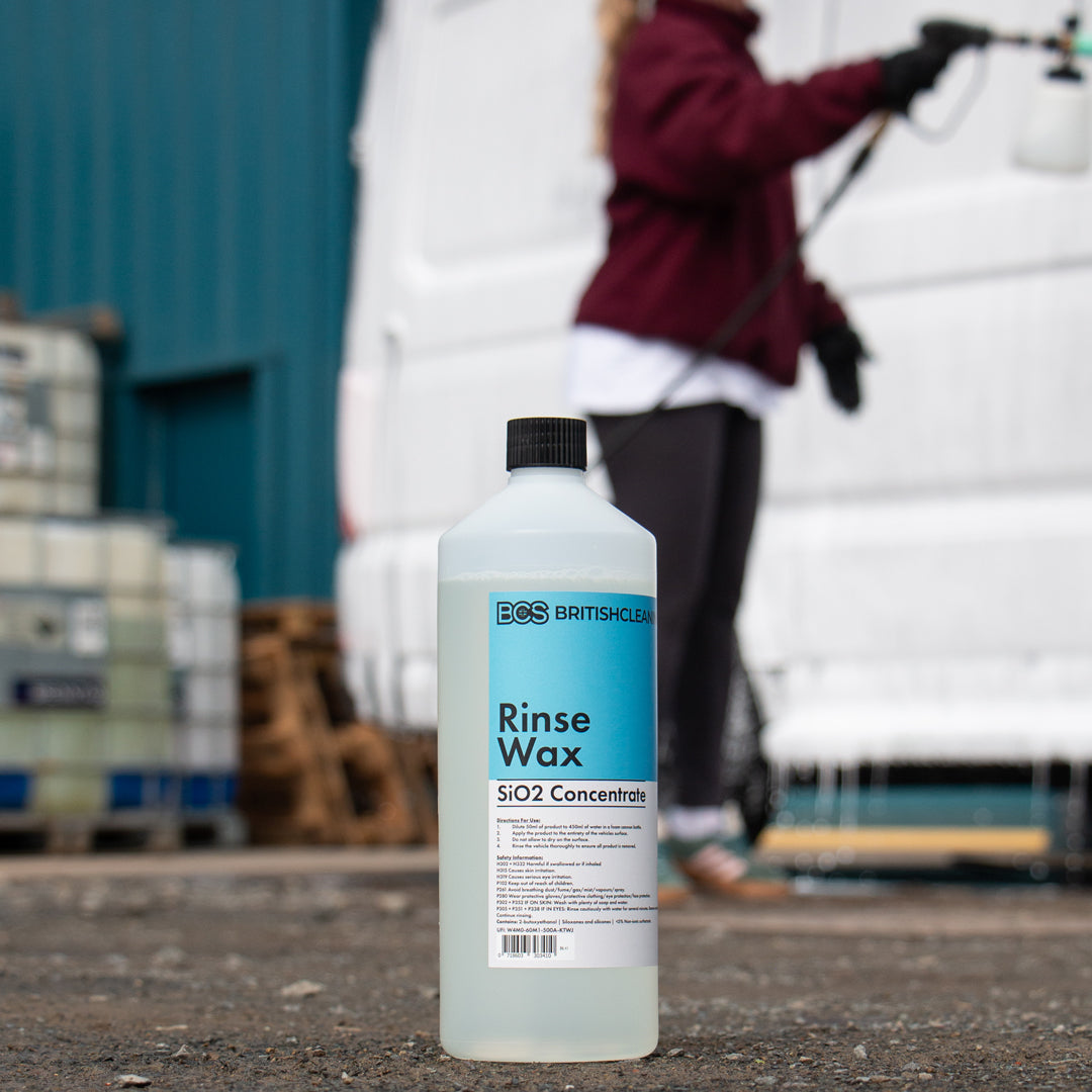 BCS Rinse Wax bottle with a person cleaning a vehicle in the background
