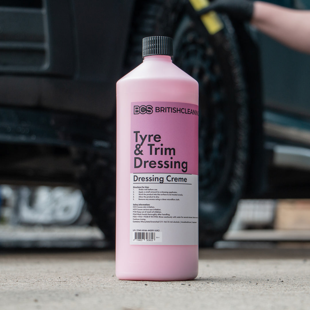 person dressing tyre behind a bottle of BCS Tyre & Trim Dressing