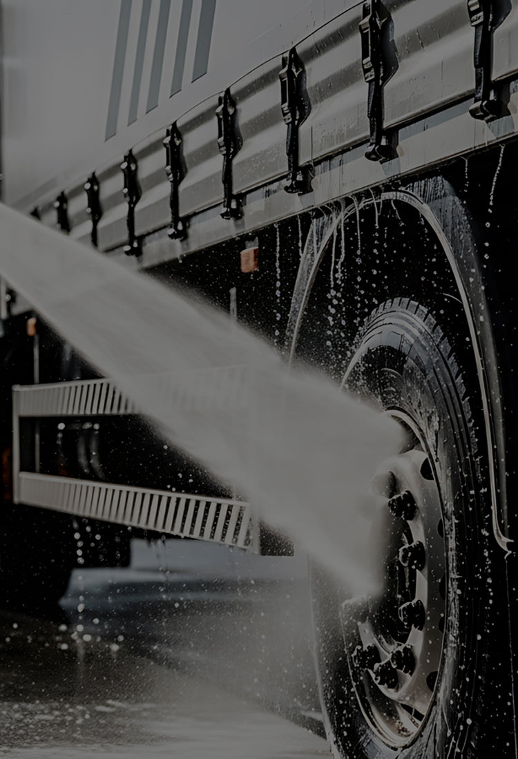 Truck being rinsed with pressure wash system.
