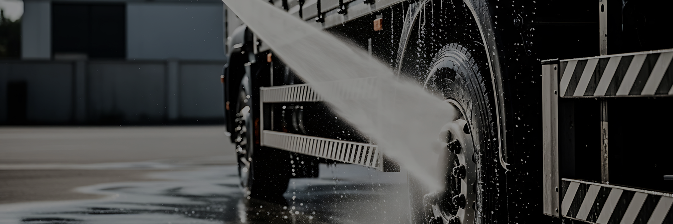 Commercial truck being cleaned with a pressure washer